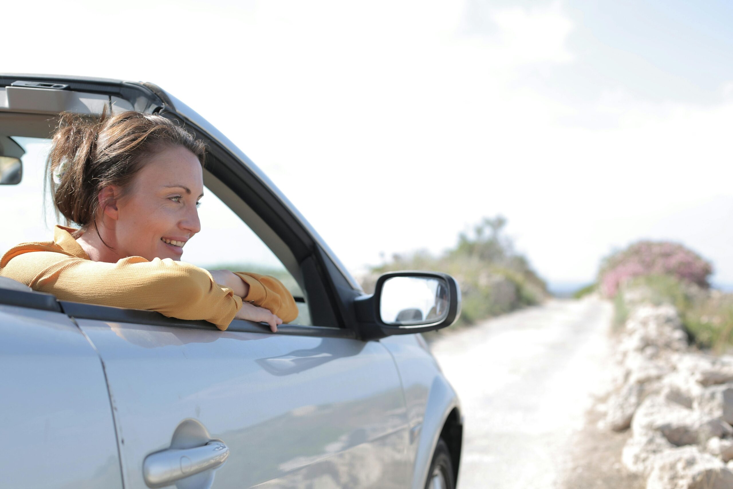 Femme au volant d'une voiture décapotable